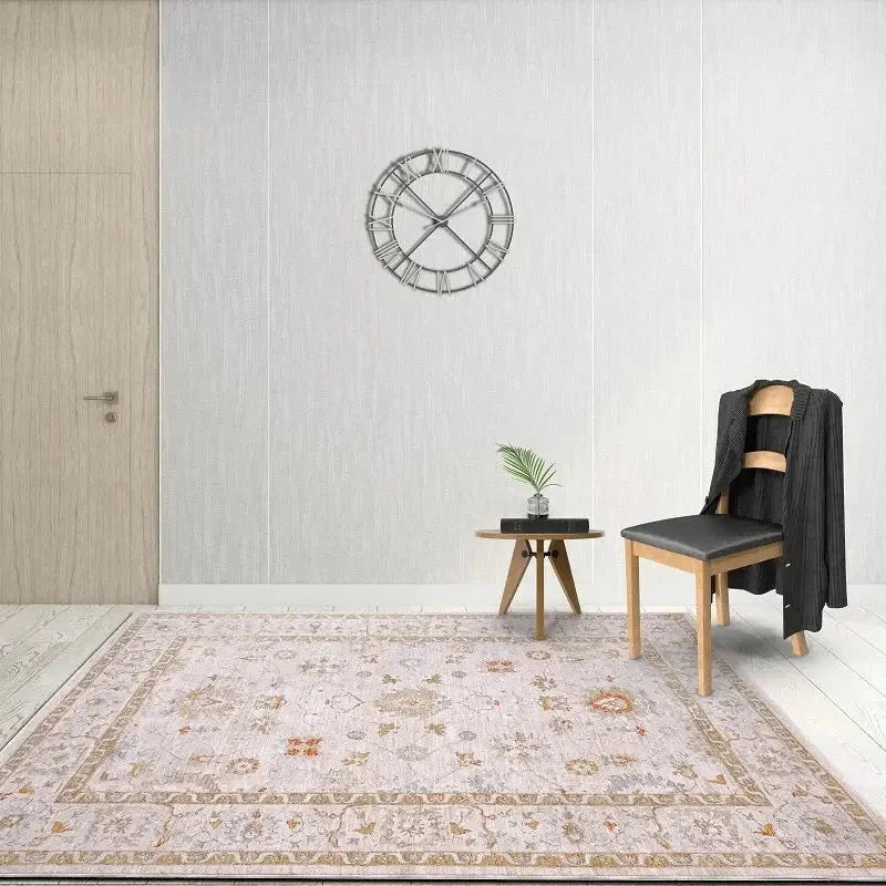 Living room with a patterned rug, chair, small table, and decorative clock on the wall.