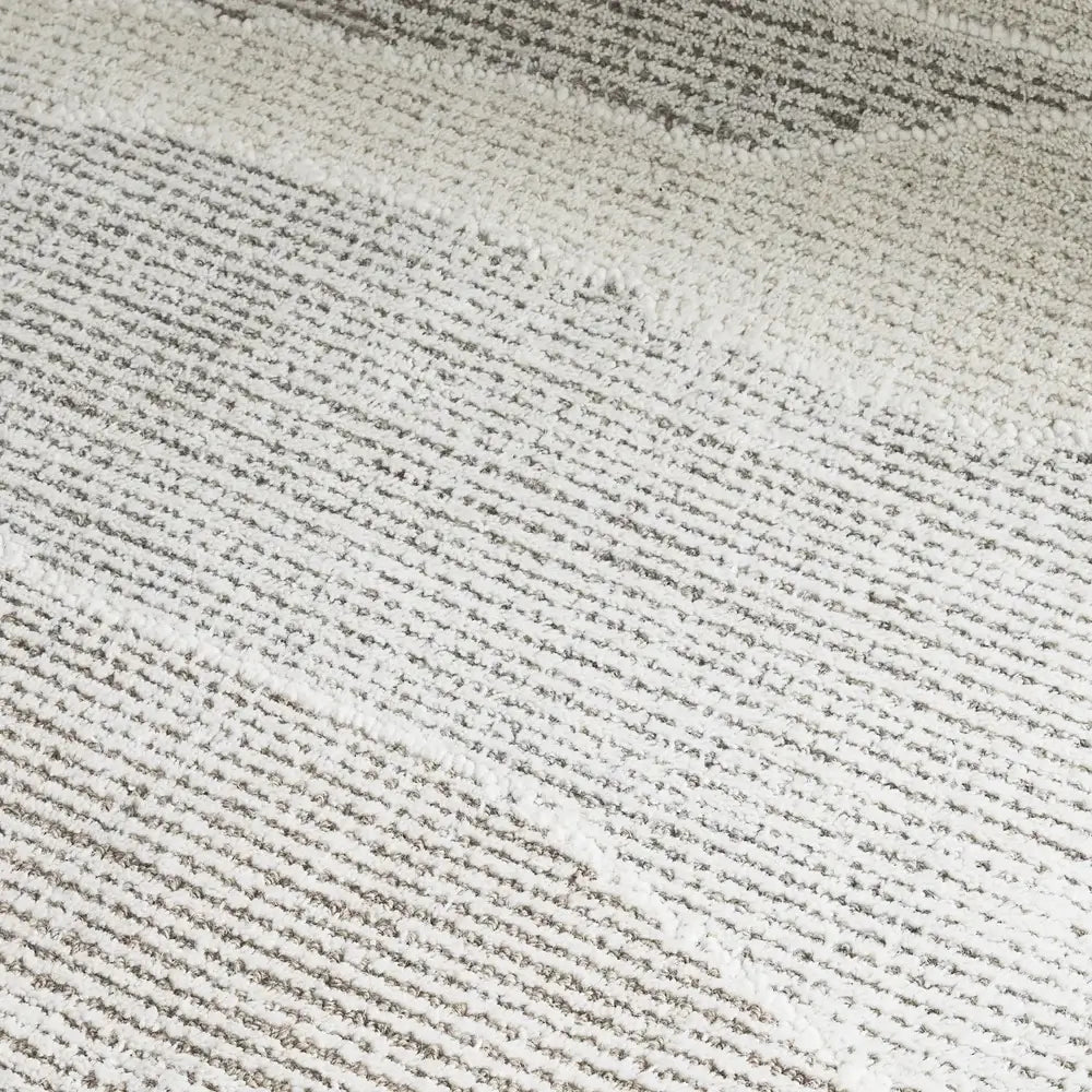 Close-up of a textured woven fabric with horizontal ribbed stripes in off-white and light gray.